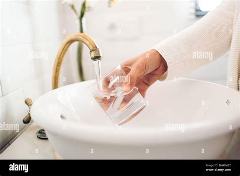 Filling A Glass Of Water In The Bathroom Sink Stock Photo Alamy