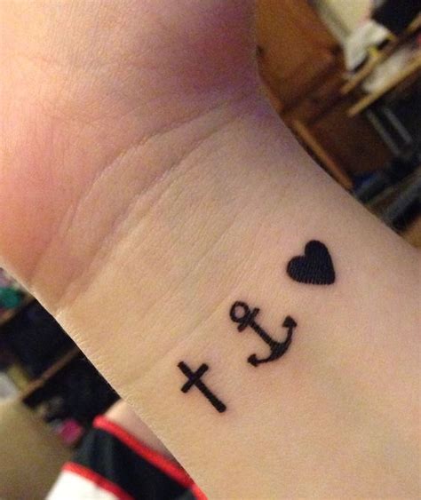 Black ink anchor with heart tattoo on. Anchor for strength, cross for faith, heart for love. But ...
