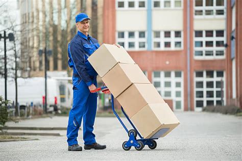 Best Worker Pushing Trolley With Boxes Stock Photos Pictures And Royalty