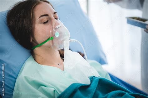 Babe Woman Patient Receiving Oxygen Mask Lying On A Hospital Bed Concept Of Medical And