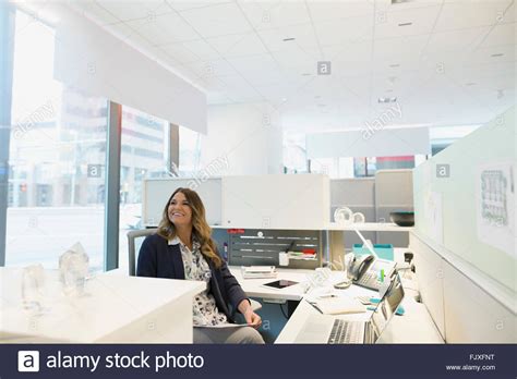 Smiling Young Businesswoman At Cubicle In Urban Office Stock Photo Alamy