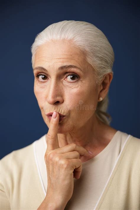 Close Up Portrait Of Beautiful Old Woman Showing Silence Gesture Stock