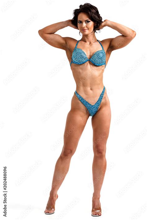 Sexy Woman Bodybuilder Is Posing Against White Background Isolated