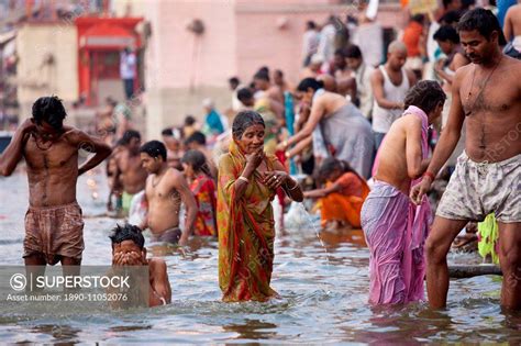 Indian Hindu Pilgrims Bathing In The Ganges River At Dashashwamedh Ghat In Holy City Of Varanasi