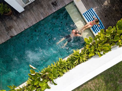 Drone View Of A Couple Relaxing On The Swimming Pool Of A Balinese
