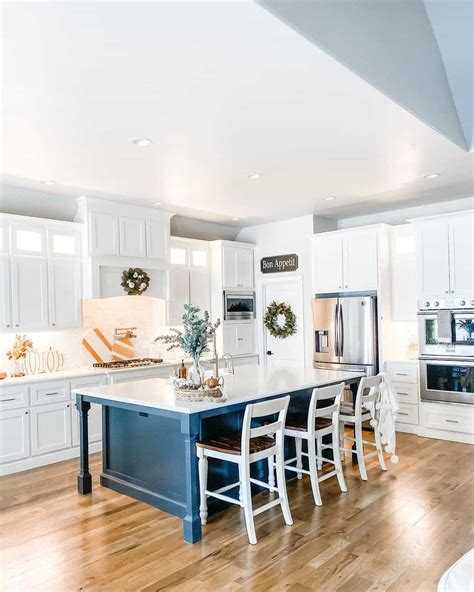 Open Concept White Kitchen With An Indigo Blue Island Soul And Lane