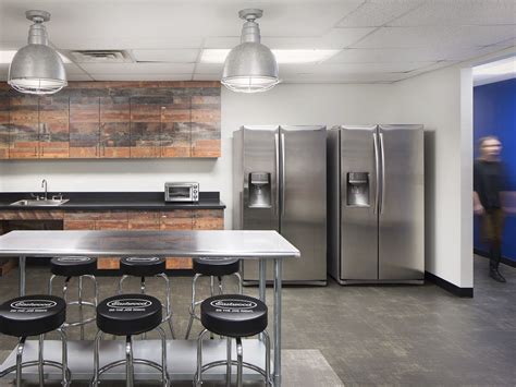 Maybe you would like to learn more about one of these? Modern break room with branded chairs, metal table and ...