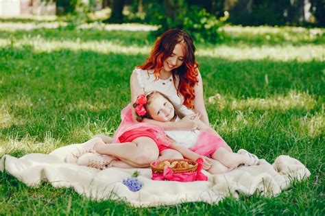 free photo redhead mother and daughter in the park