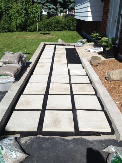 Concrete pavers can mimic the look of brick but are manufactured and produced in molds, resulting in a uniform look in size and color. Our DIY Front Path Makeover | Diy patio pavers, Diy patio ...