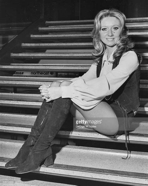 Portrait Of Singer Clodagh Rodgers Sitting On A Staircase At Heathrow