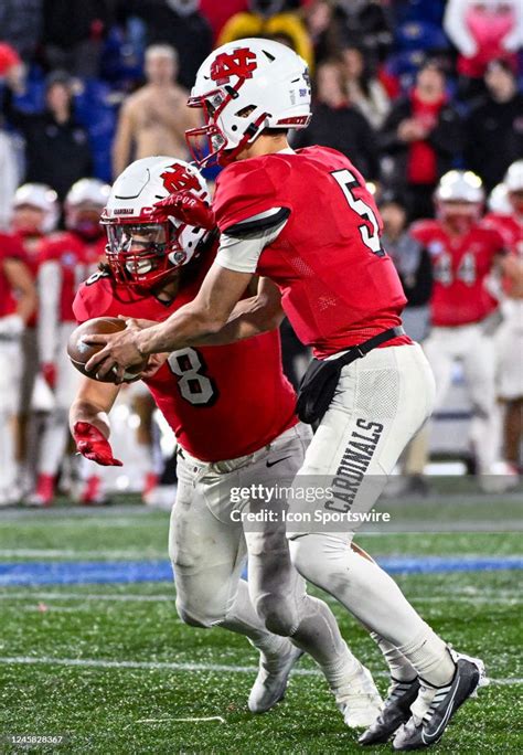 North Central College Cardinals Quarterback Luke Lehnen Hands The