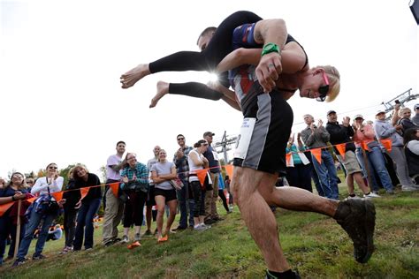 Couples compete for partner's weight in beer at annual wife carrying ...