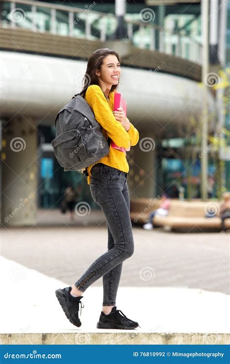 Smiling Female College Student Walking To Class With Bag Stock Photo
