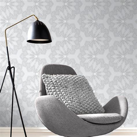 A Chair And Lamp In Front Of A Wallpapered Room With An Intricate Pattern