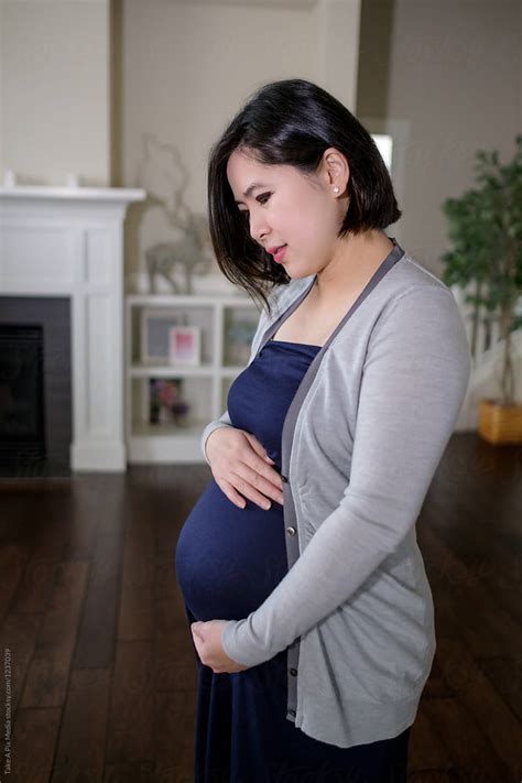 pregnant asian woman at home by stocksy contributor take a pix media stocksy