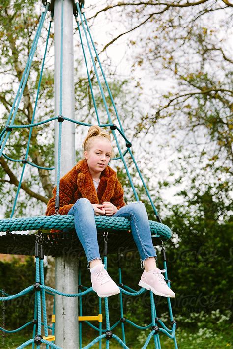 Pre Teenage Girl At A Playground By Helen Rushbrook