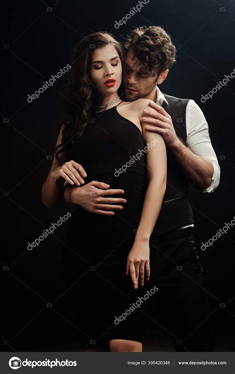 Man Embracing Touching Shoulder Seductive Woman Isolated Black Stock