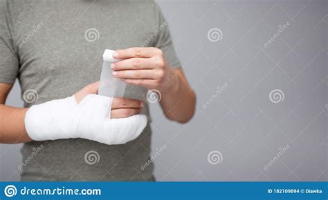 Fracture And First Aid Concept Close Up Of Young Man Bandaging His