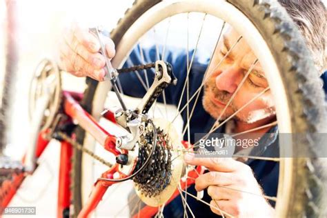 Older Man Fixing Bike Photos And Premium High Res Pictures Getty Images
