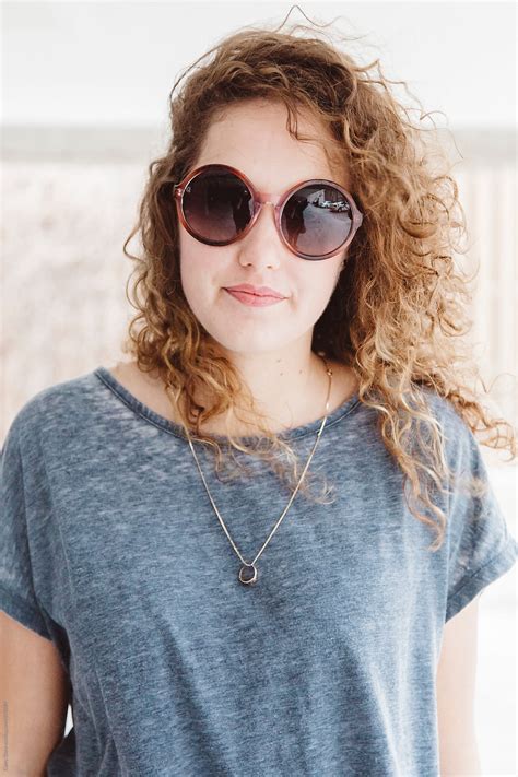 Cute Young Woman Wearing Round Sunglasses By Stocksy Contributor