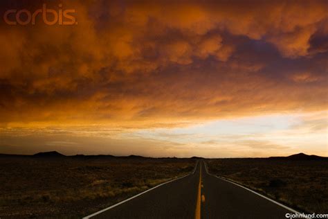 Beautiful Desert Sunset And Long Straight Road