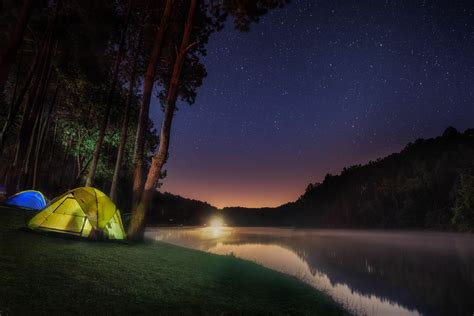 Camping In Tents By A Starlit Mountain Lake