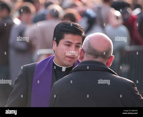 catholic priest taking confession from man in the street Via della