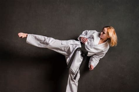 Free Photo Female Karate Fighter Kicking Front View