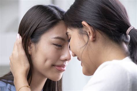 Image Of Young Pleased Lesbian Asian Women With Closed Eyes Touching Each Other Face To Face