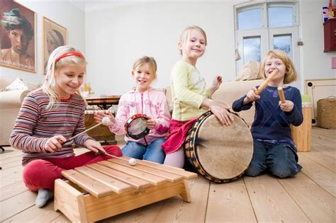Children Playing With Different Musical Instruments Stock Photo