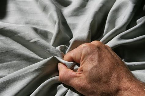 Grabbing Bed Sheet Man S Hand Grabbing A Crumpled Striped Bed Sheet