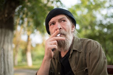 Portrait Of Homeless Old Man Smoking Old Male With Serious Face