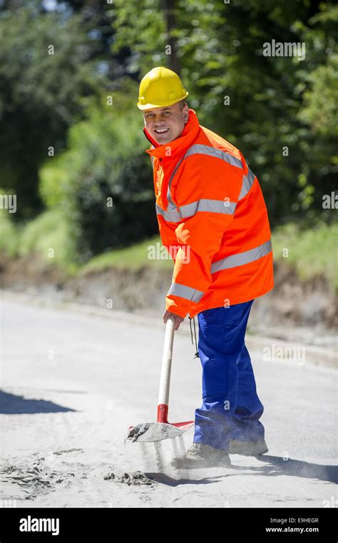 Construction Worker With Shovel In Hand Stock Photo Alamy