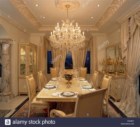 Ornate Glass Chandelier Above Table Set For Dinner In Opulent Spanish