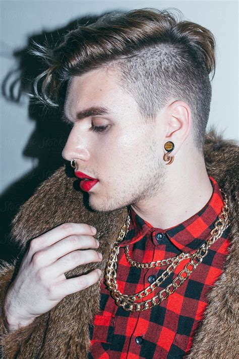 Beautiful Young Man With Red Lipstick And Golden Necklace In A Fur