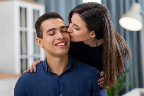 Free Photo Woman Kissing Her Husband On The Cheek Close Up