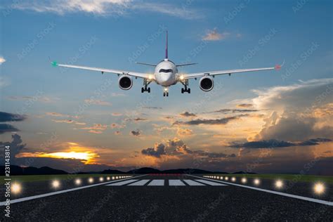 Airplane Landing In The Evening With Beautiful Sunset Background Stock
