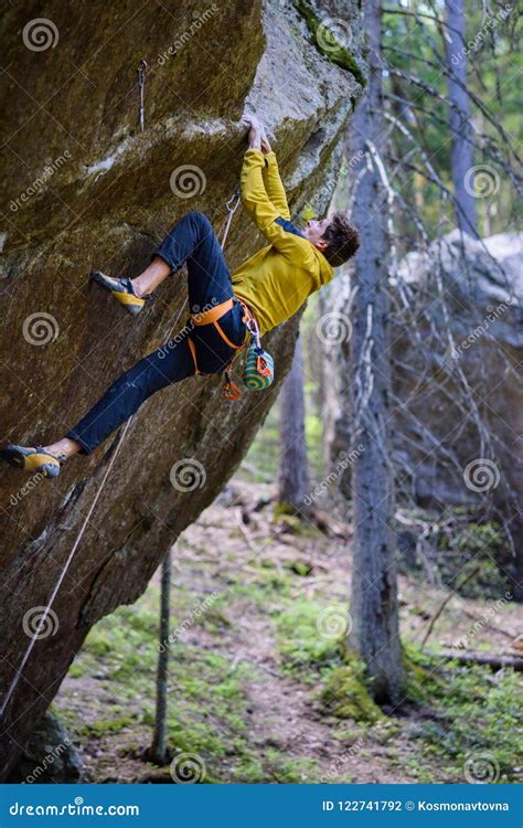 Extreme Sport Climbing Rock Climber Ascending A Challenging Cliff