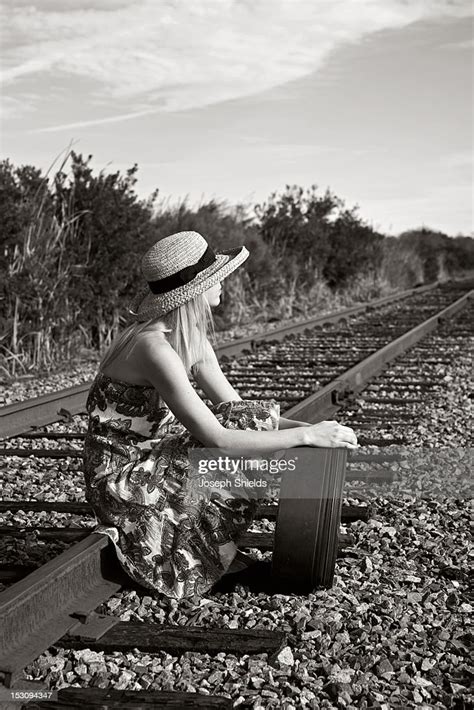 Young Woman Sitting On Railroad Tracks Stock Photo Getty Images