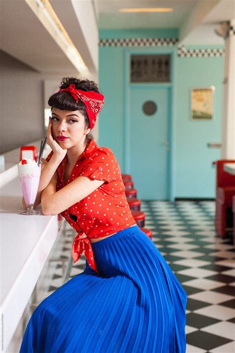 Portrait Of Beautiful Roackabilly Woman With Milkshake At Retro Diner