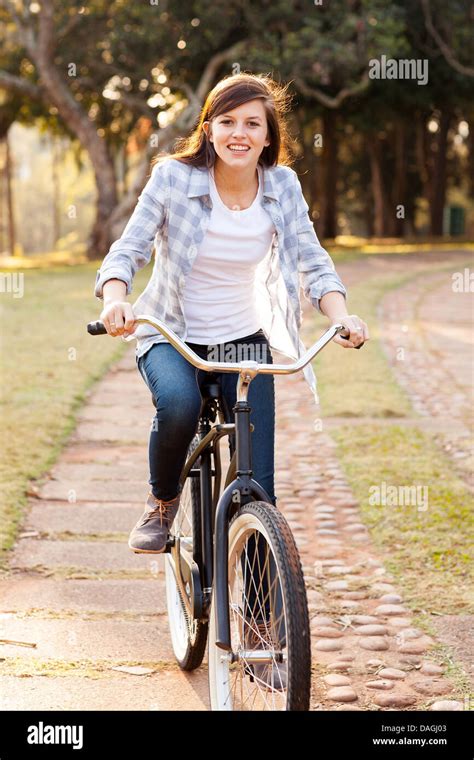 Pretty Teen Girl Riding Bicycle At The Park Stock Photo Alamy