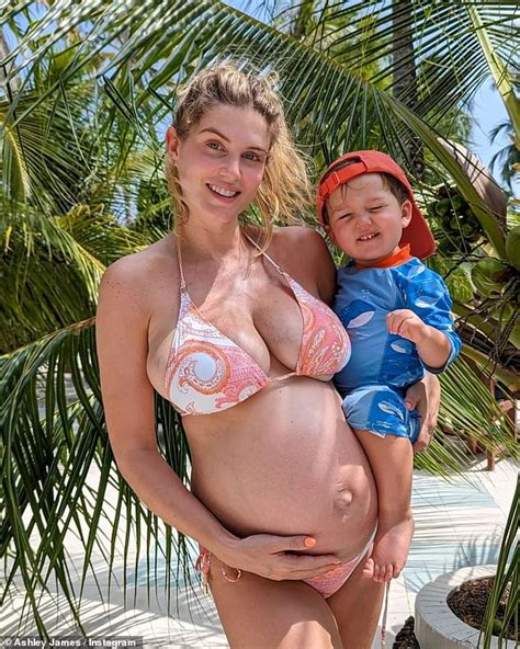 Pregnant Ashley James Shows Off Her Blossoming Bump In A Busty Bikini As She Cradles Her Son