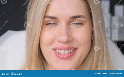 face portrait of a beautiful blonde model looking at the camera close up stock footage video