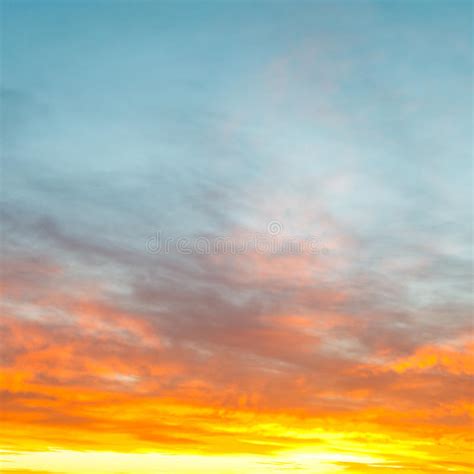 Blue Morning Sky Over Yellow Sunrise Clouds Stock Photo