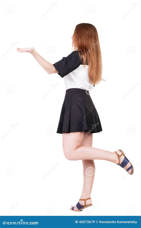 Back View Of Beautiful Woman In Dress Looking At Wall And Holds Stock