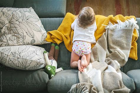 Child Laying On The Couch By Stocksy Contributor Meaghan Curry