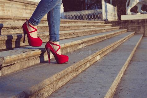 Woman Wearing Blue Jeans And Red High Heel Shoes In Old Town The Women