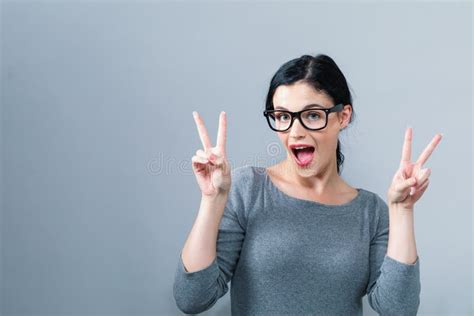 Young Woman Giving The Peace Sign Stock Image Image Of Fingers