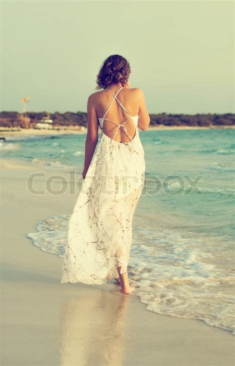 Woman In White Dress Walking On The Stock Image Colourbox