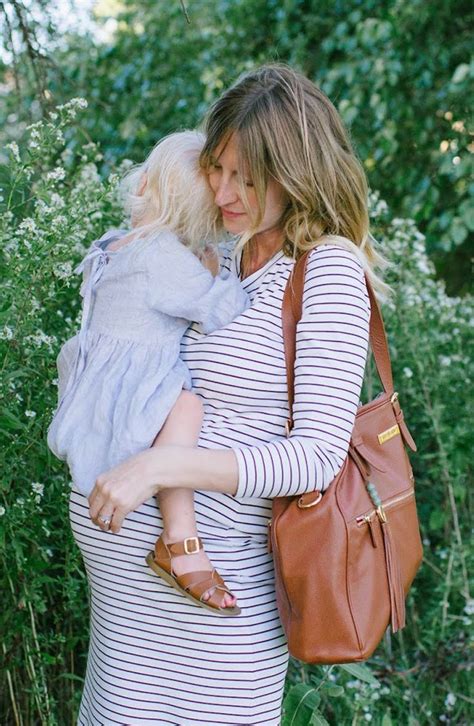motherhood is a job invest in the gear that works this leather backpack diaper bag transforms